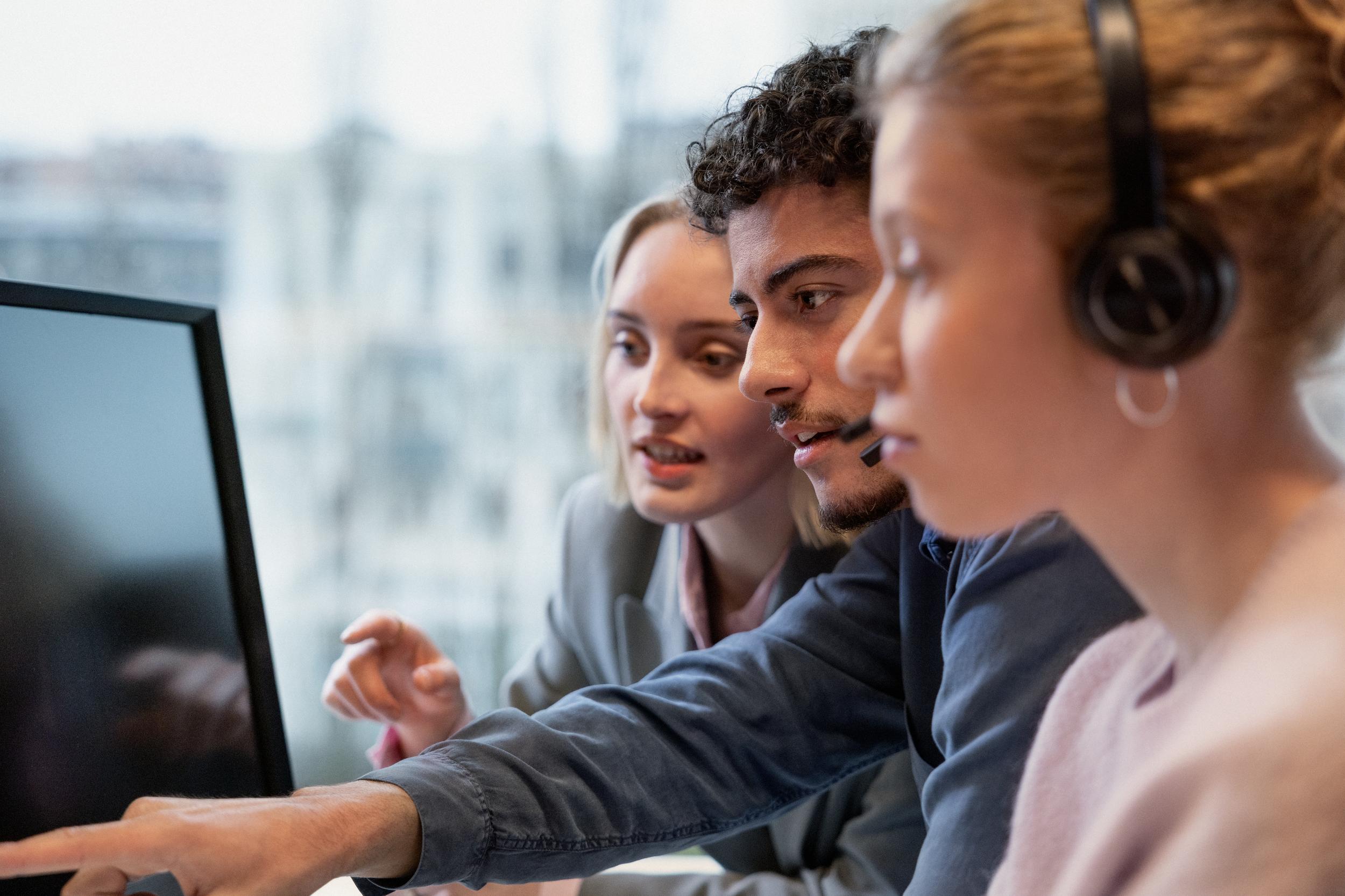 Three people in front of computer